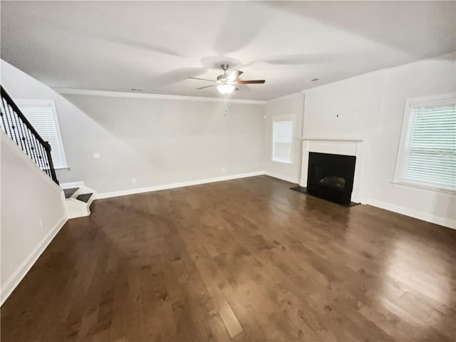 3650 Lindsy Brooke Ct, Douglasville, GA 30135 - unfurnished living room with ceiling fan, crown molding, a fireplace with flush hearth, dark wood-style floors, and baseboards