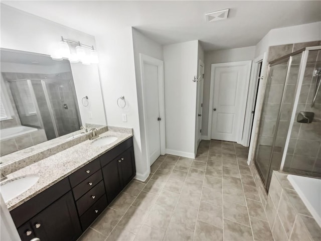 3650 Lindsy Brooke Ct, Douglasville, GA 30135 - bathroom featuring a stall shower, double vanity, a garden tub, and tile patterned flooring