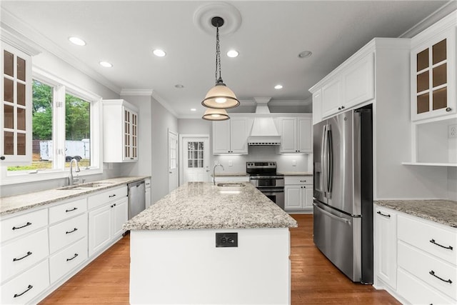 4777 Destitute Way, Gainesville, GA 30506 - kitchen featuring appliances with stainless steel finishes, a sink, a center island with sink, ornamental molding, and white cabinetry