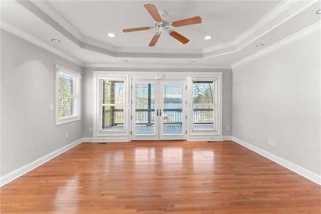 4777 Destitute Way, Gainesville, GA 30506 - spare room featuring a raised ceiling, light wood-style floors, ceiling fan, baseboards, and ornamental molding