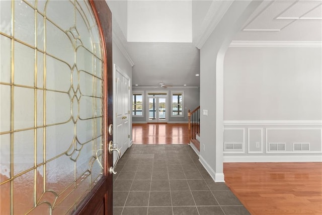 4777 Destitute Way, Gainesville, GA 30506 - entrance foyer featuring ornamental molding, stairs, arched walkways, dark tile patterned flooring, and baseboards