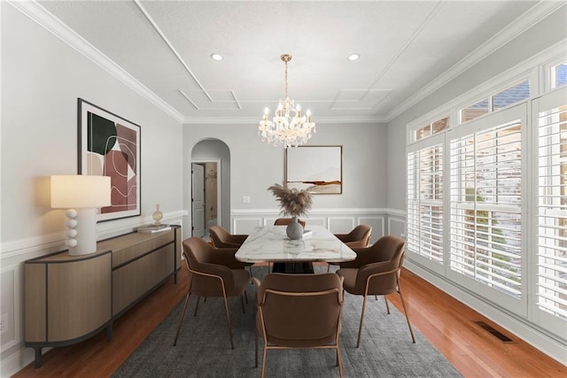 4777 Destitute Way, Gainesville, GA 30506 - dining space featuring arched walkways, plenty of natural light, wood finished floors, a chandelier, and crown molding