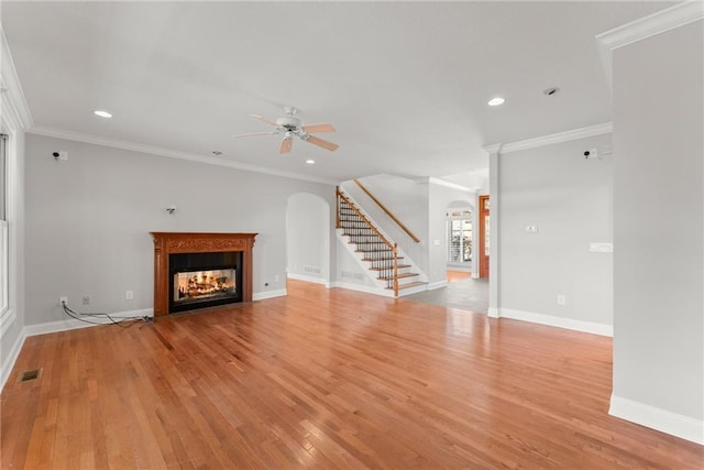 4777 Destitute Way, Gainesville, GA 30506 - unfurnished living room featuring arched walkways, ceiling fan, stairway, a multi sided fireplace, and wood finished floors