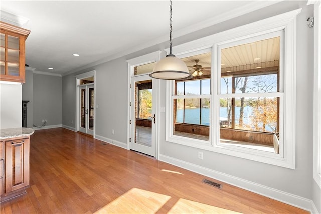 4777 Destitute Way, Gainesville, GA 30506 - unfurnished dining area with crown molding, wood finished floors, baseboards, a water view, and recessed lighting