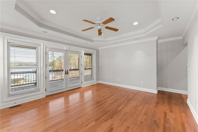 4777 Destitute Way, Gainesville, GA 30506 - unfurnished room featuring a tray ceiling, light wood-style floors, ceiling fan, baseboards, and ornamental molding
