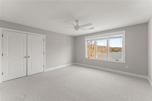 4777 Destitute Way, Gainesville, GA 30506 - unfurnished bedroom featuring baseboards, light colored carpet, a closet, and a ceiling fan