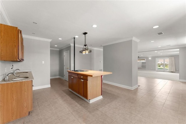 4777 Destitute Way, Gainesville, GA 30506 - kitchen featuring a sink, decorative backsplash, crown molding, brown cabinets, and baseboards