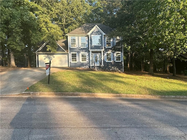 view of front of house featuring a front yard and a garage