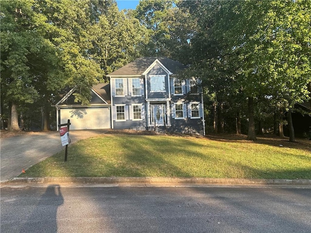 view of front of house with a front lawn and a garage