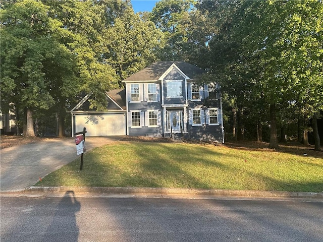 view of front of house with a garage and a front lawn