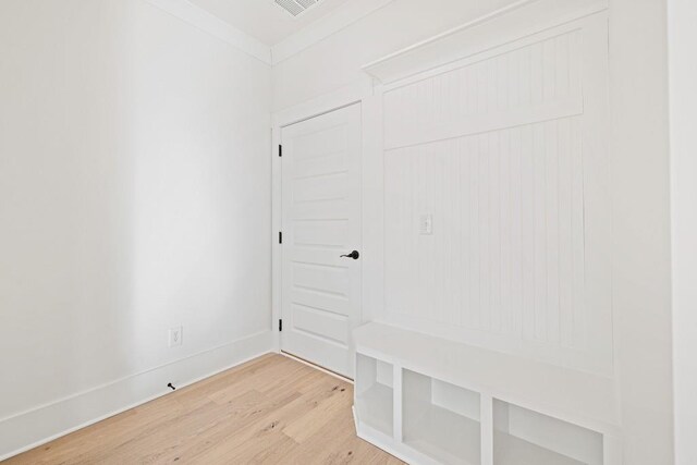 mudroom featuring hardwood / wood-style flooring and ornamental molding