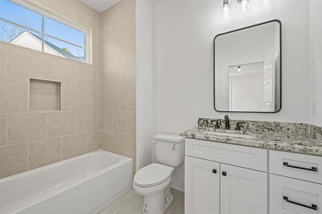 bathroom featuring vanity, washtub / shower combination, tile patterned floors, and toilet