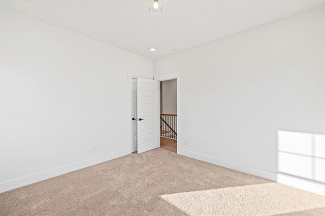 carpeted spare room with baseboards