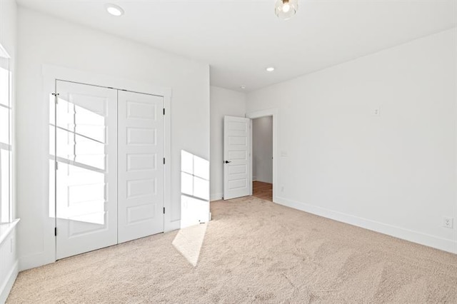 unfurnished bedroom featuring carpet floors, recessed lighting, and baseboards