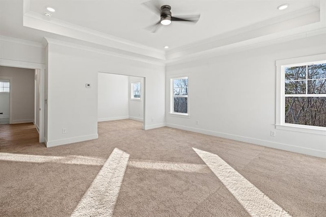 interior space with crown molding, recessed lighting, a tray ceiling, and light colored carpet