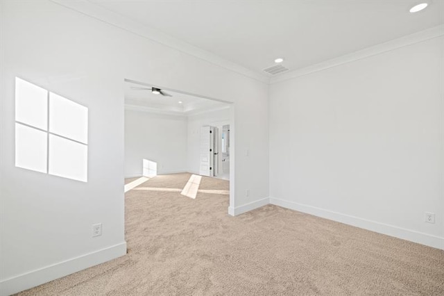 carpeted empty room with crown molding, baseboards, and recessed lighting