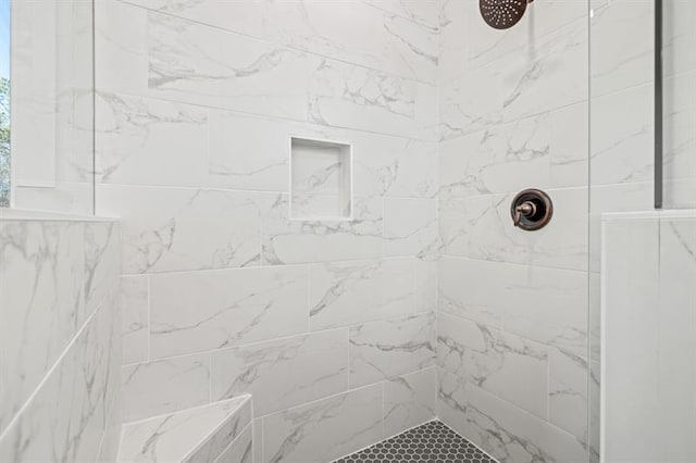 bathroom with a tile shower