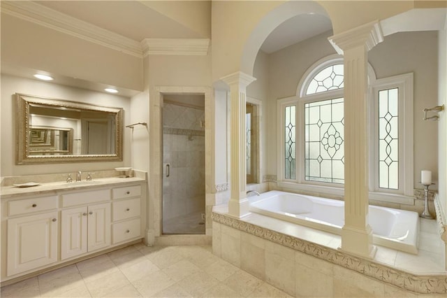 full bathroom with a stall shower, decorative columns, a garden tub, crown molding, and vanity