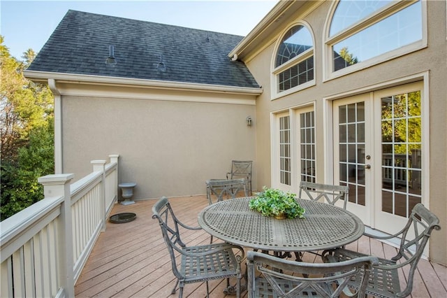 wooden deck featuring outdoor dining area and french doors