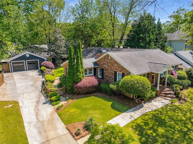 view of front facade with driveway, a garage, brick siding, and a shingled roof