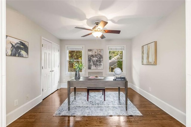 office space with ceiling fan, baseboards, and wood finished floors