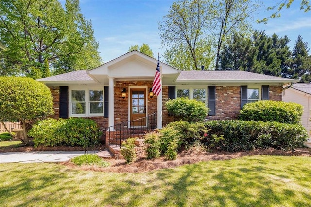 ranch-style home with a front lawn and brick siding