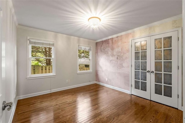 unfurnished room with french doors, wood finished floors, ornamental molding, and baseboards