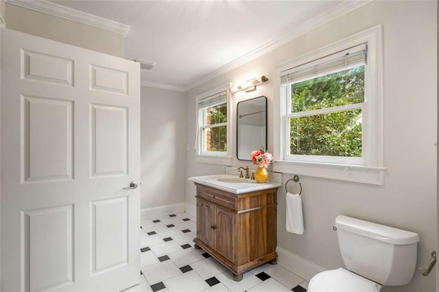 bathroom featuring tile patterned floors, baseboards, vanity, toilet, and ornamental molding