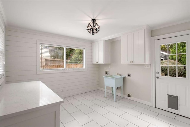 clothes washing area featuring hookup for an electric dryer, hookup for a washing machine, cabinet space, plenty of natural light, and crown molding