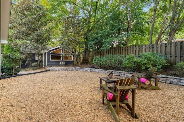 view of yard with an outdoor fire pit and fence