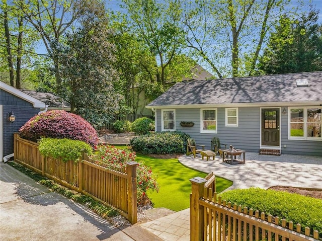 view of yard featuring a patio, fence, and an outdoor fire pit