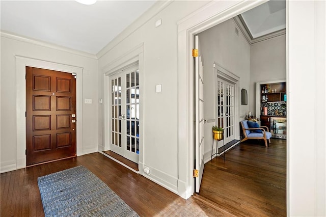 entrance foyer featuring wood finished floors, french doors, baseboards, and ornamental molding