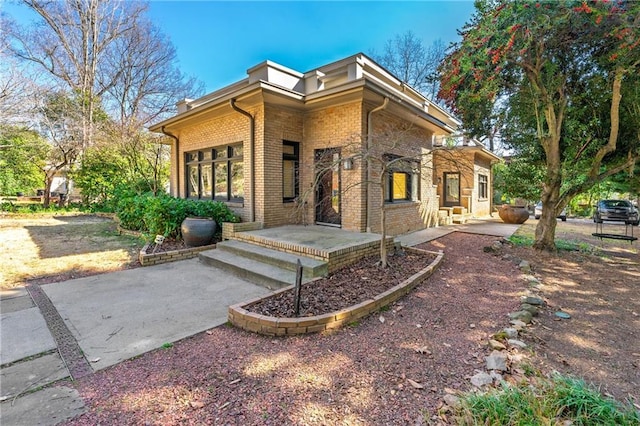 exterior space featuring brick siding