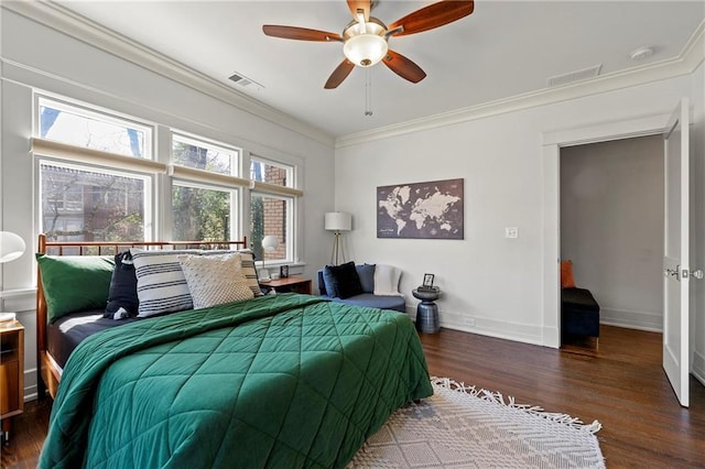 bedroom featuring visible vents, crown molding, baseboards, and wood finished floors