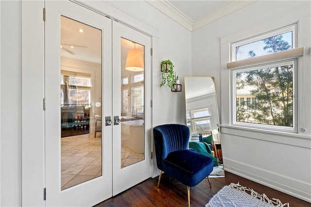 sitting room with a healthy amount of sunlight, french doors, and ornamental molding