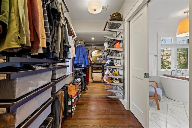 spacious closet with marble finish floor