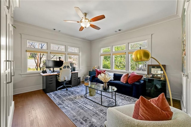 office with baseboards, visible vents, ceiling fan, hardwood / wood-style flooring, and crown molding