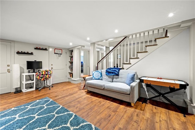 living room featuring stairs, recessed lighting, and wood finished floors