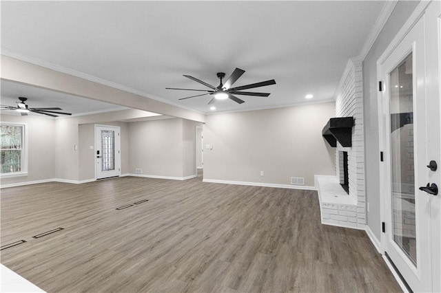 unfurnished living room featuring a fireplace, hardwood / wood-style flooring, ceiling fan, and ornamental molding