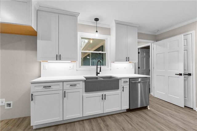 kitchen featuring dishwasher, white cabinetry, sink, hanging light fixtures, and ornamental molding