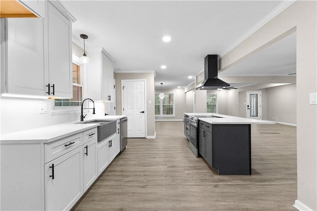 kitchen featuring white cabinetry, a center island, island exhaust hood, and appliances with stainless steel finishes