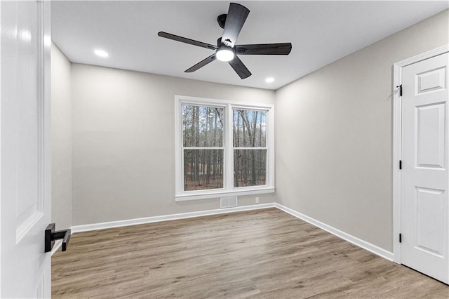 unfurnished room with ceiling fan and light hardwood / wood-style floors