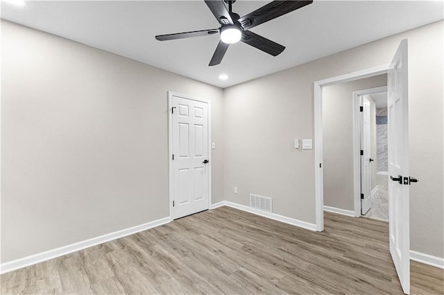 empty room featuring light wood-type flooring and ceiling fan