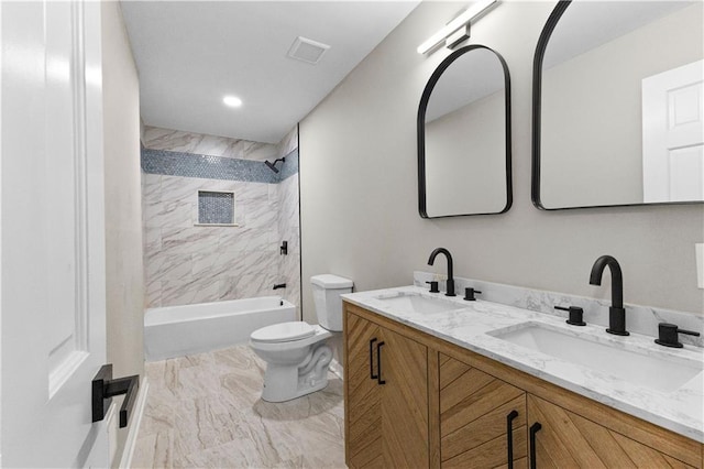 full bathroom featuring toilet, tiled shower / bath, and vanity