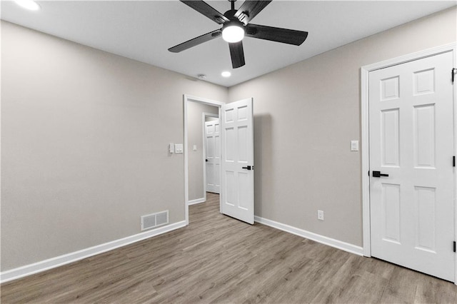 unfurnished bedroom featuring ceiling fan and light hardwood / wood-style flooring