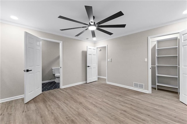 unfurnished bedroom with light hardwood / wood-style floors, ensuite bath, ceiling fan, and ornamental molding