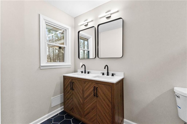 bathroom with toilet and vanity