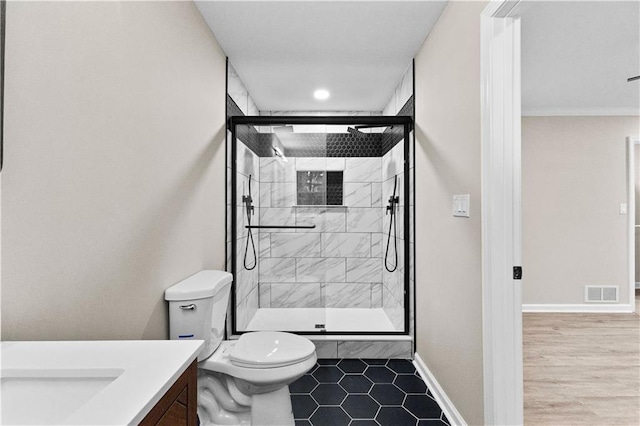 bathroom featuring vanity, toilet, and an enclosed shower