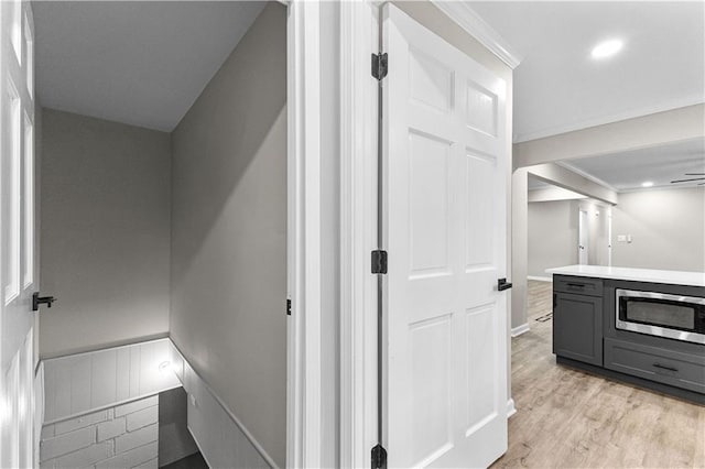 hall featuring crown molding and light wood-type flooring