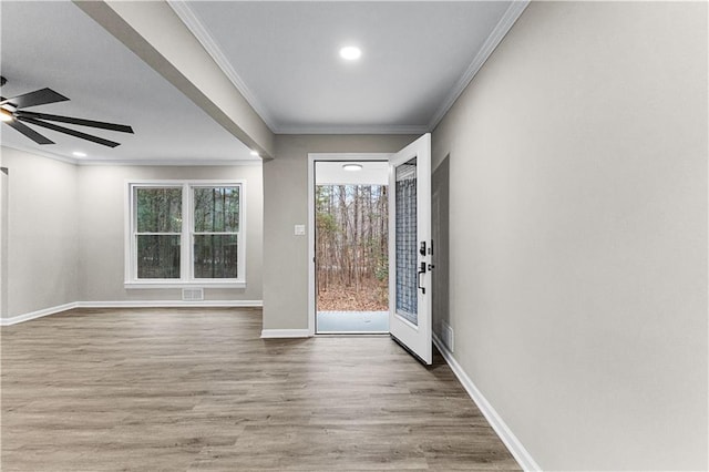 foyer with hardwood / wood-style flooring, ceiling fan, and ornamental molding